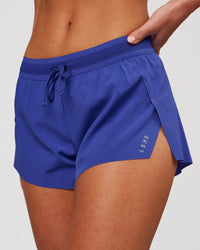 Woman wearing Accelerate 3" Mid-Rise Running Short - Power Cobalt | Model:Issy | Size:XS | Thumbnail Index: 0