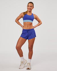 Woman wearing Accelerate 3" Mid-Rise Running Short - Power Cobalt | Model:Issy | Size:XS | Thumbnail Index: 3