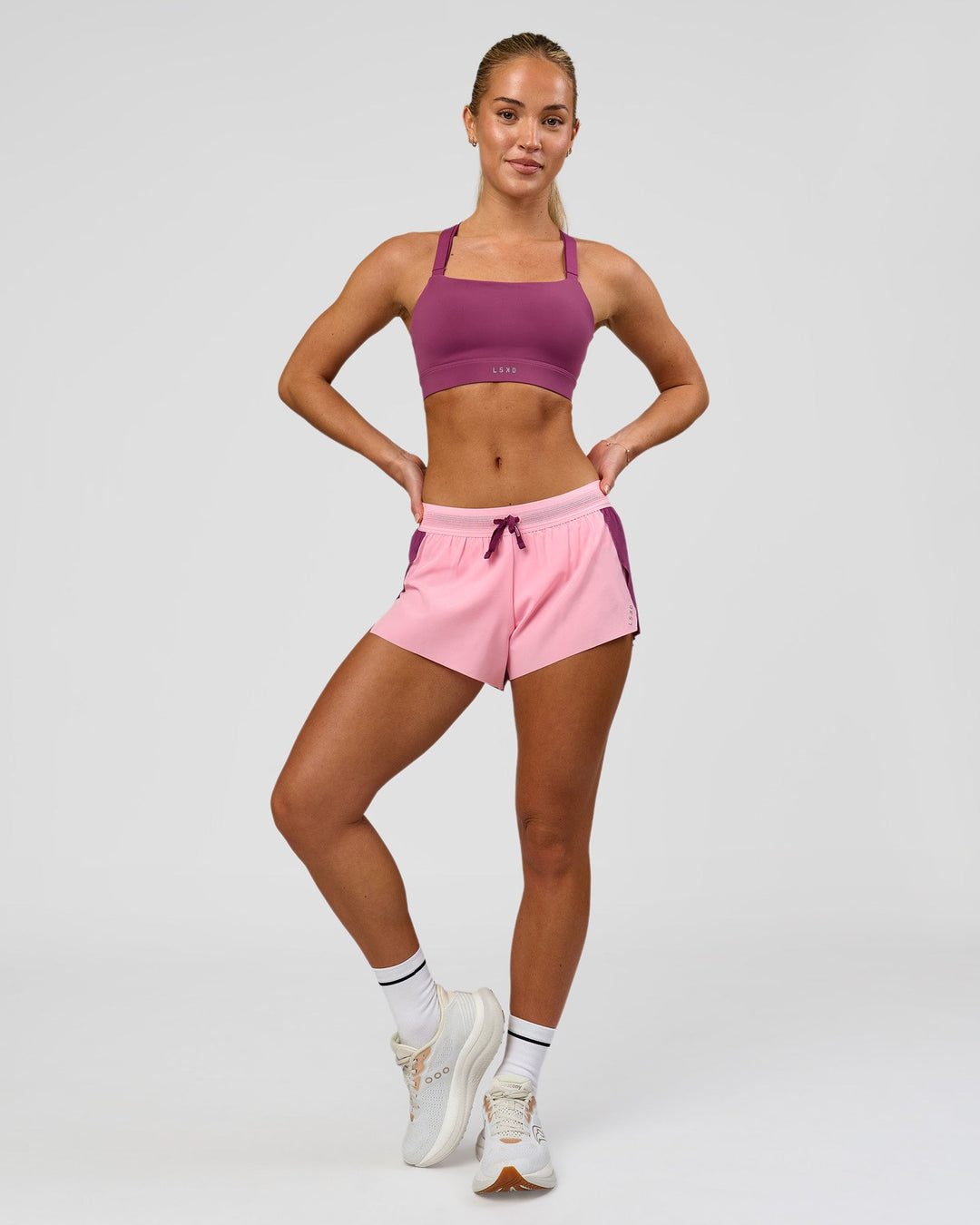Woman wearing Accelerate 3" Mid-Rise Running Short - Boysenberry-Pink Rose | Model:Issy | Size:XS - view 3