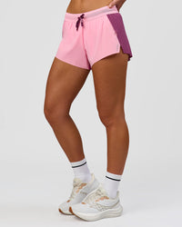 Woman wearing Accelerate 3" Mid-Rise Running Short - Boysenberry-Pink Rose | Model:Issy | Size:XS | Thumbnail Index: 1