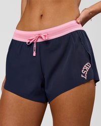 Woman wearing Accelerate 3" Mid-Rise Running Short - Future Navy-Varsity Print | Model:Issy | Size:XS | Thumbnail Index: 1