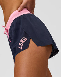 Woman wearing Accelerate 3" Mid-Rise Running Short - Future Navy-Varsity Print | Model:Issy | Size:XS | Thumbnail Index: 3