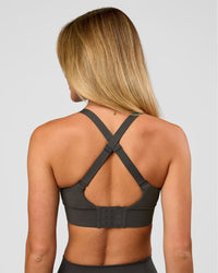 Woman wearing Accelerate Sports Bra - Onyx | Model:Issy | Size:XS | Thumbnail Index: 3