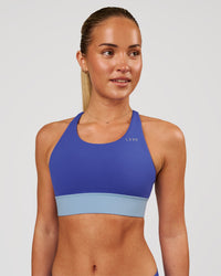 Woman wearing Accelerate Sports Bra - Power Cobalt-Open Air | Model:Issy | Size:XS | Thumbnail Index: 0