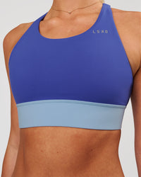 Woman wearing Accelerate Sports Bra - Power Cobalt-Open Air | Model:Issy | Size:XS | Thumbnail Index: 1