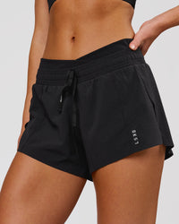 Woman wearing Accelerate Synergy 3" Running Short Short - Black-Black | Model:Issy | Size:XS | Thumbnail Index: 0