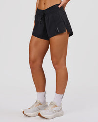Woman wearing Accelerate Synergy 3" Running Short Short - Black-Black | Model:Issy | Size:XS | Thumbnail Index: 1