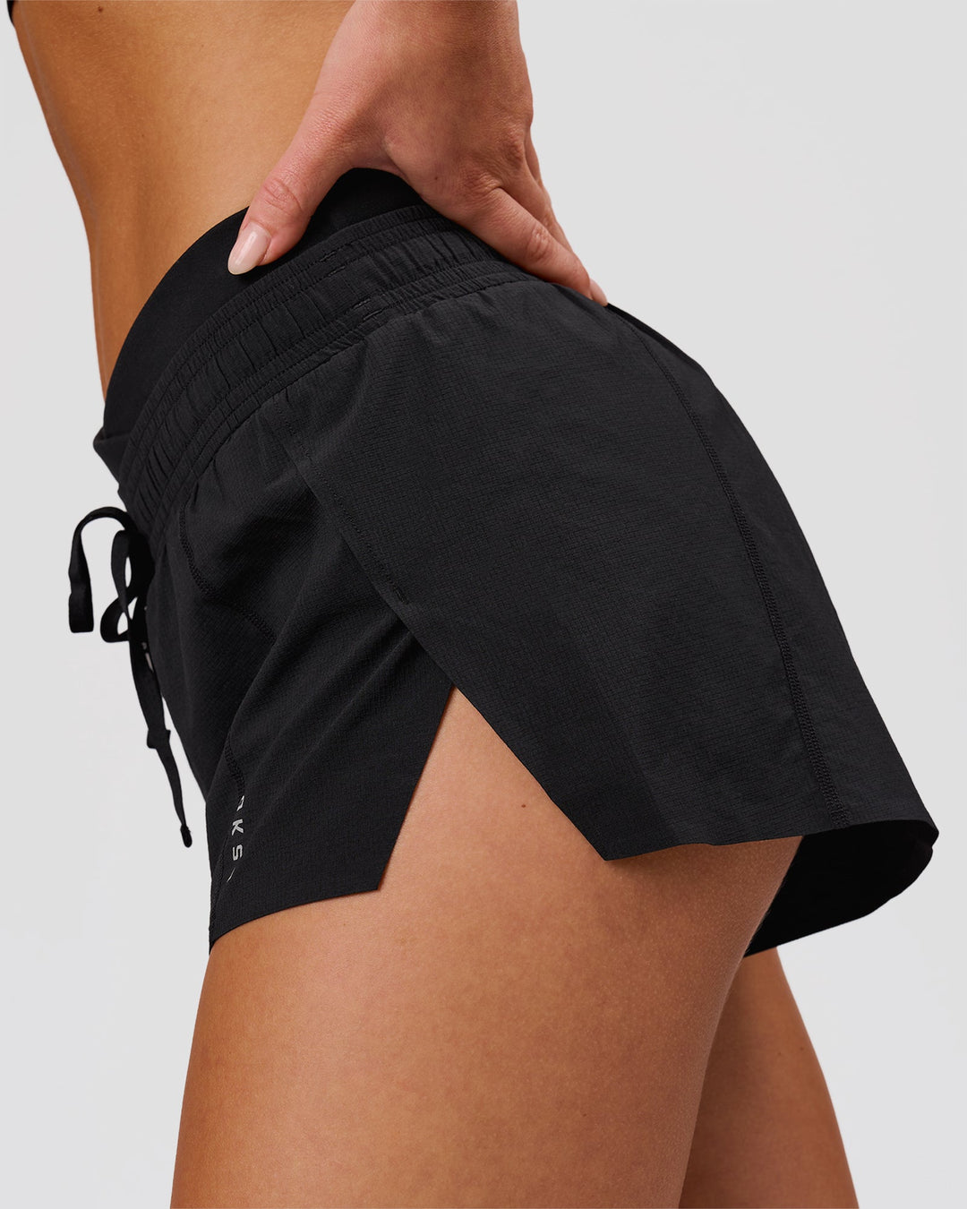 Woman wearing Accelerate Synergy 3" Running Short Short - Black-Black | Model:Issy | Size:XS - view 7