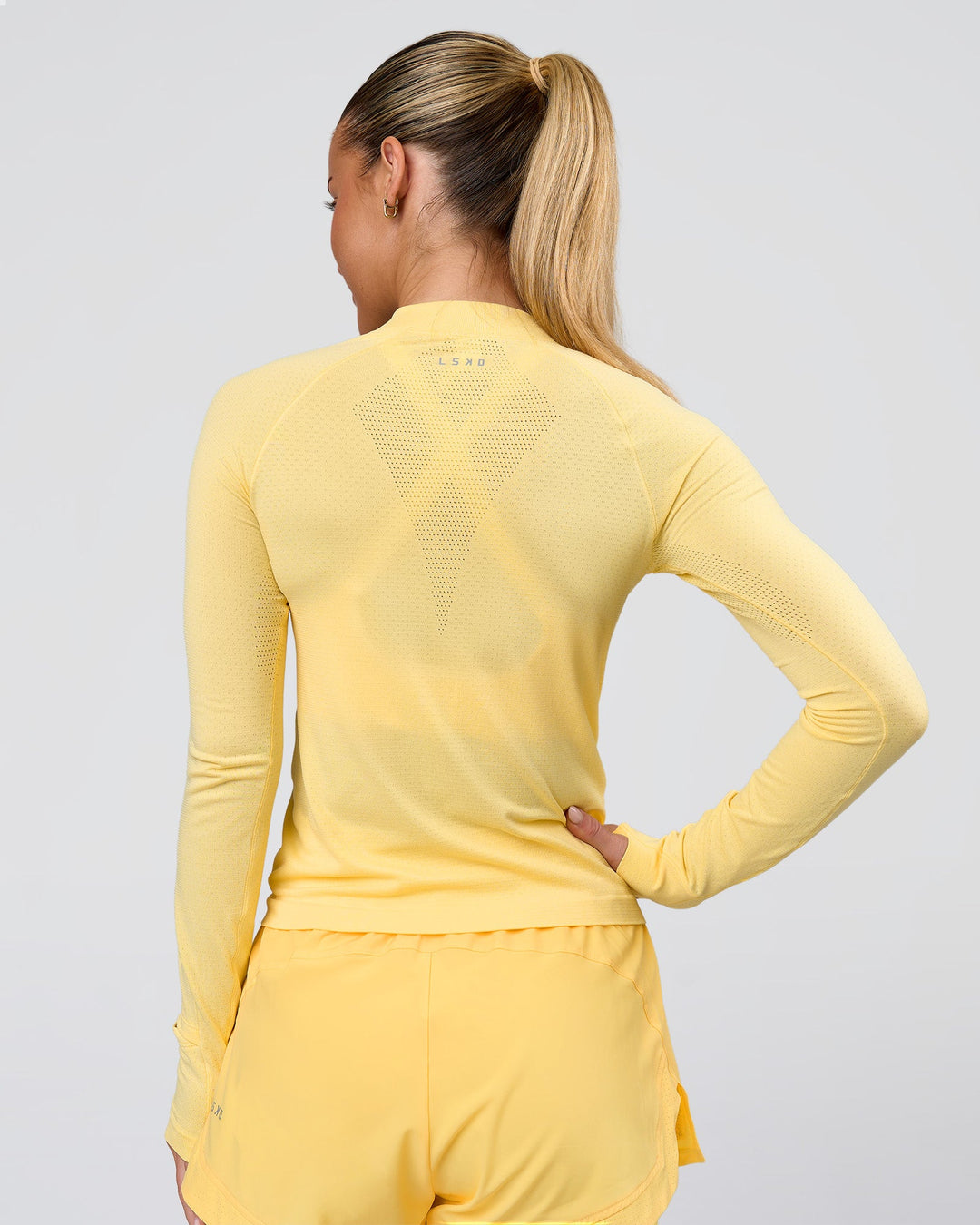 Woman wearing AeroFLX+ Long Sleeve Half Zip - Lemon/Lemon | Model:Issy | Size:XS - view 3