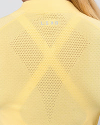 Woman wearing AeroFLX+ Long Sleeve Half Zip - Lemon/Lemon | Model:Issy | Size:XS | Thumbnail Index: 3