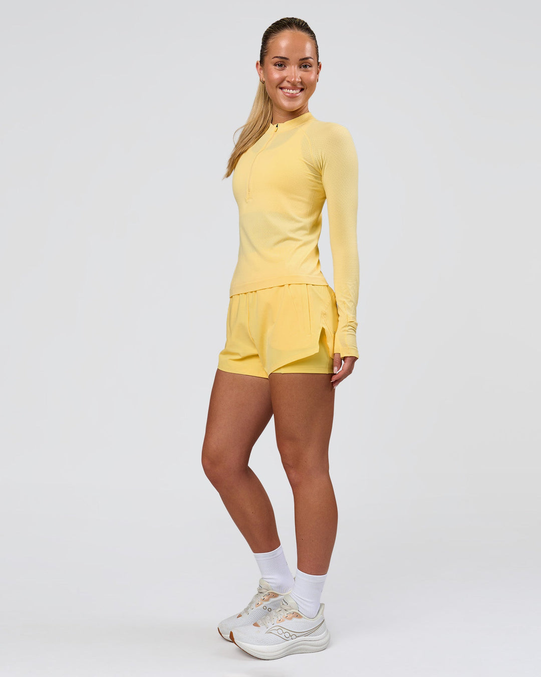 Woman wearing AeroFLX+ Long Sleeve Half Zip - Lemon/Lemon | Model:Issy | Size:XS - view 5