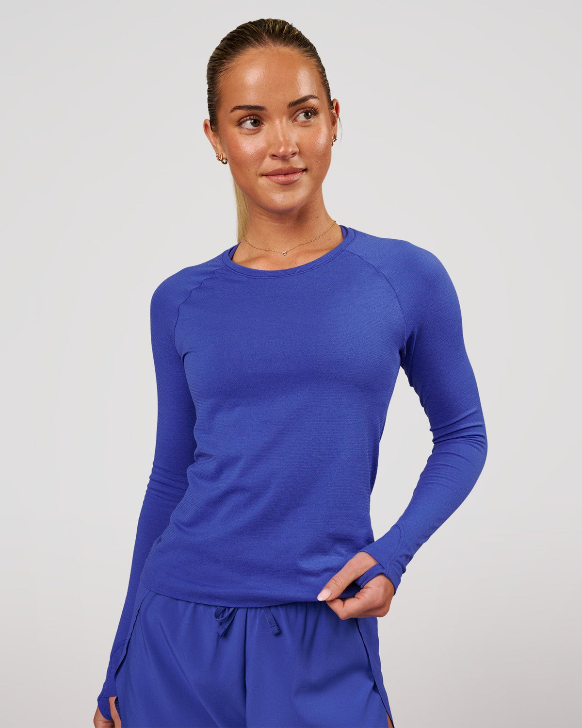 Woman wearing Aeroflx+ Seamless Long Sleeve Tee in Power Cobalt | Model: Issy | Size: XS