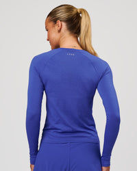 Woman wearing Aeroflx+ Seamless Long Sleeve Tee in Power Cobalt | Model: Issy | Size: XS | Thumbnail Index: 2