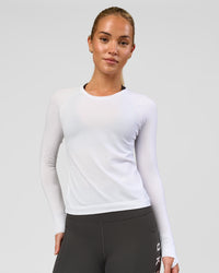 Woman wearing AeroFLX+ Seamless Long Sleeve Tee - White/White | Model:Issy | Size:XS | Thumbnail Index: 0