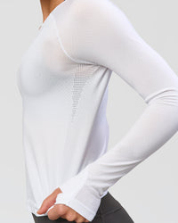 Woman wearing AeroFLX+ Seamless Long Sleeve Tee - White/White | Model:Issy | Size:XS | Thumbnail Index: 5