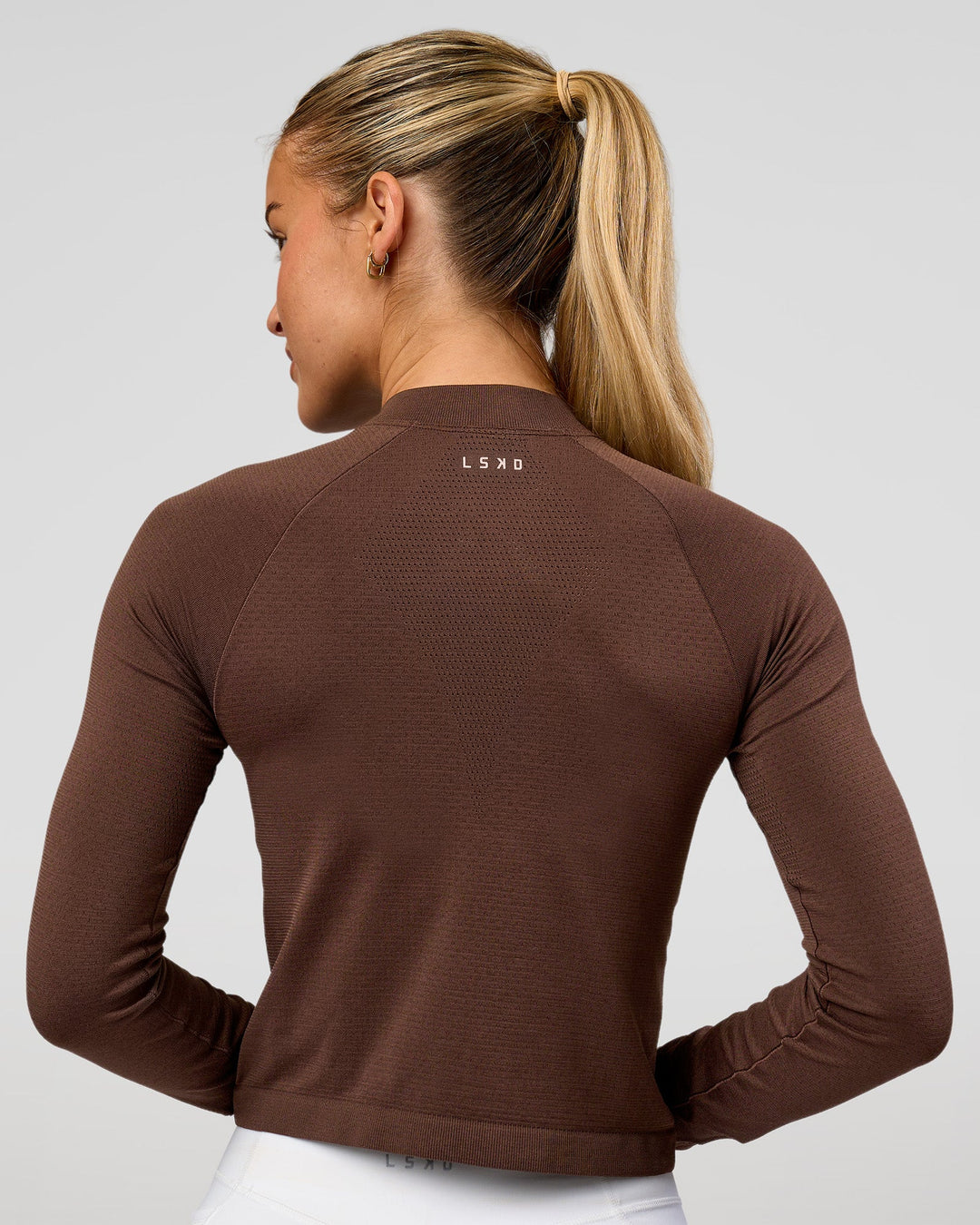 Woman wearing AeroFLX+ Long Sleeve Skimmer Half Zip - Hot Chocolate/Hot Chocolate | Model:Issy | Size:XS - view 3