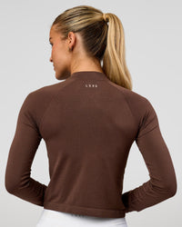 Woman wearing AeroFLX+ Long Sleeve Skimmer Half Zip - Hot Chocolate/Hot Chocolate | Model:Issy | Size:XS | Thumbnail Index: 2