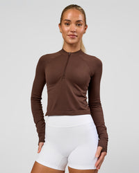Woman wearing AeroFLX+ Long Sleeve Skimmer Half Zip - Hot Chocolate/Hot Chocolate | Model:Issy | Size:XS | Thumbnail Index: 5
