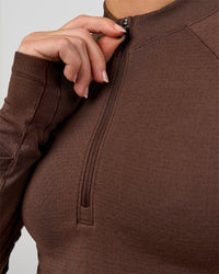 Woman wearing AeroFLX+ Long Sleeve Skimmer Half Zip - Hot Chocolate/Hot Chocolate | Model:Issy | Size:XS | Thumbnail Index: 7