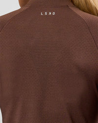 Woman wearing AeroFLX+ Long Sleeve Skimmer Half Zip - Hot Chocolate/Hot Chocolate | Model:Issy | Size:XS | Thumbnail Index: 12
