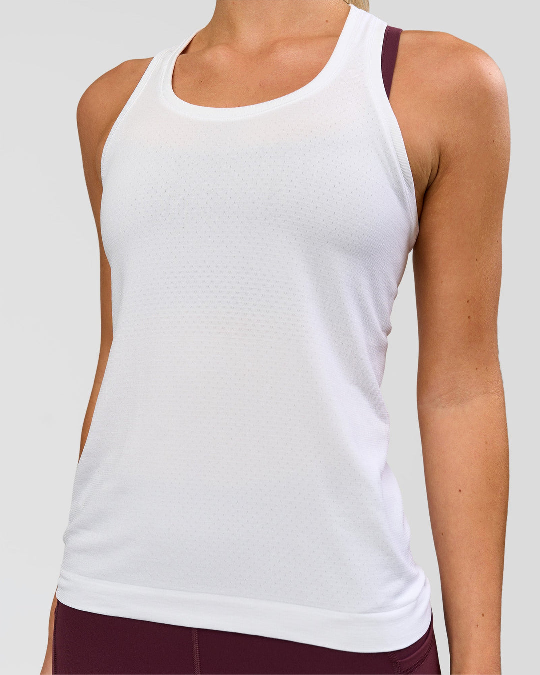 Woman wearing AeroFLX+ Seamless Tank - White/White | Model:Issy | Size:XS - view 1
