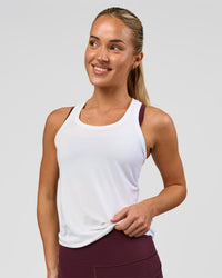 Woman wearing AeroFLX+ Seamless Tank - White/White | Model:Issy | Size:XS | Thumbnail Index: 1