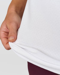 Woman wearing AeroFLX+ Seamless Tank - White/White | Model:Issy | Size:XS | Thumbnail Index: 6