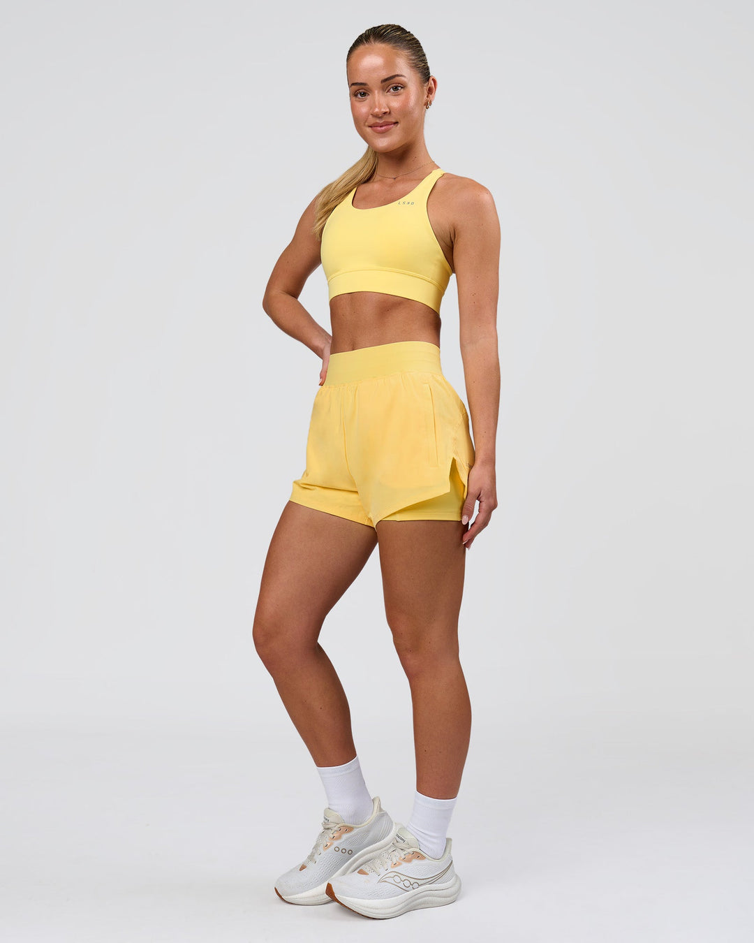 Woman wearing Challenger 3" Lined Performance Short - Lemon | Model:Issy | Size:XS - view 3