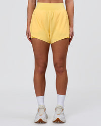 Woman wearing Challenger 3" Lined Performance Short - Lemon | Model:Issy | Size:XS | Thumbnail Index: 5