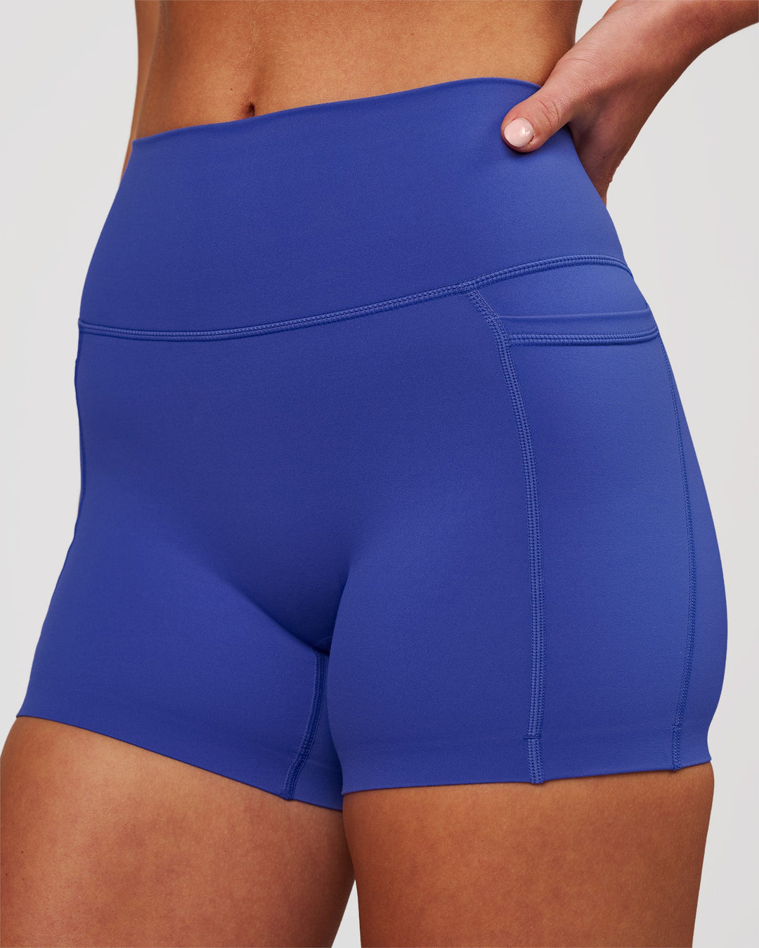 Woman wearing Elixir High-Rise 4" Short Pockets - Power Cobalt | Model:Issy | Size:XS - view 1