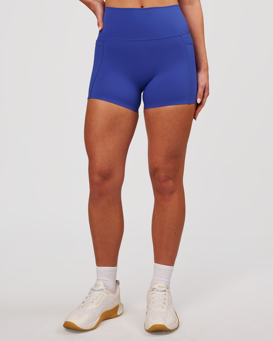 Woman wearing Elixir High-Rise 4" Short Pockets - Power Cobalt | Model:Issy | Size:XS - view 5