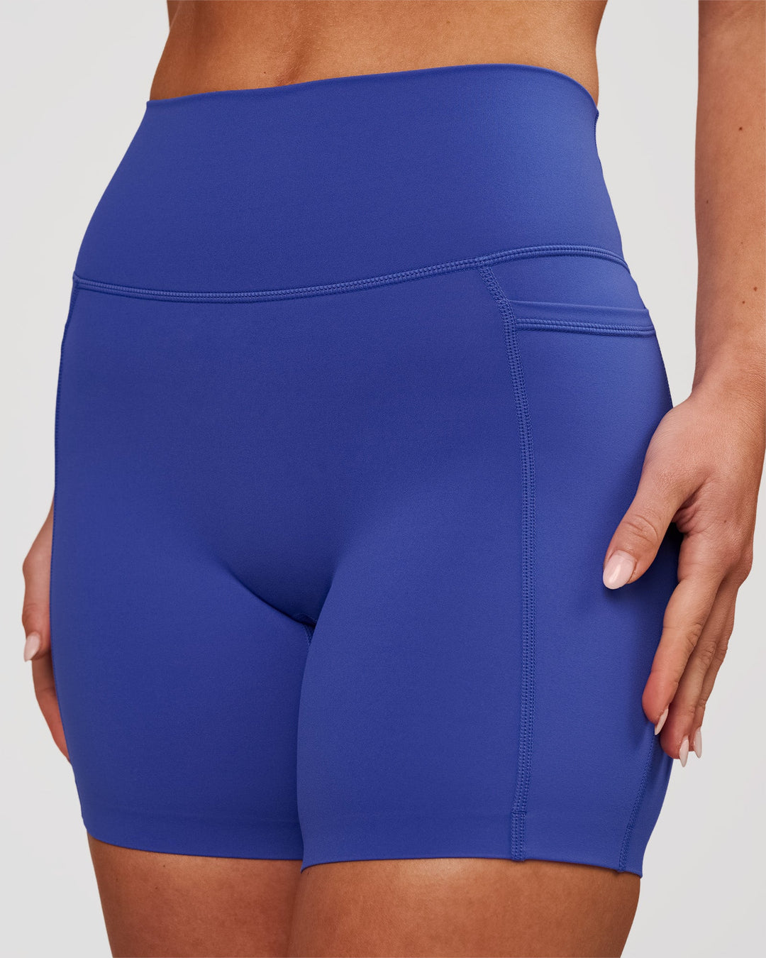 Woman wearing Elixir High-Rise 6" Short Pockets - Power Cobalt | Model:Issy | Size:XS - view 3