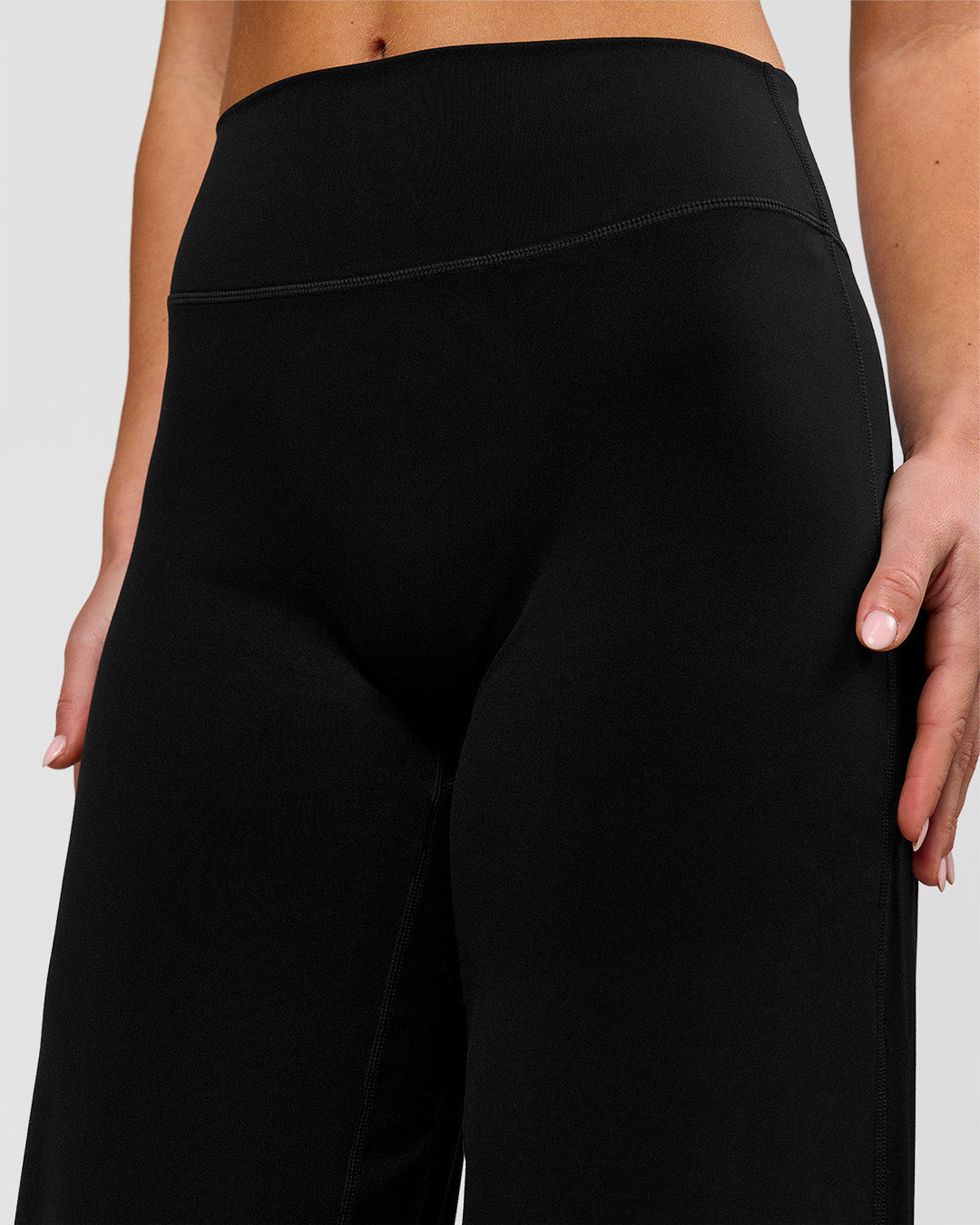 Woman wearing Elixir High-Rise Petite Pant - Black | Model:Issy | Size:XS - view 3