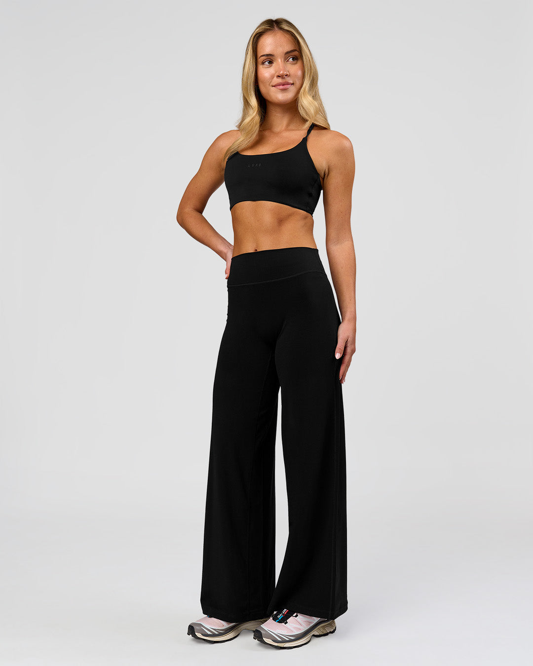 Woman wearing Elixir High-Rise Petite Pant - Black | Model:Issy | Size:XS - view 5