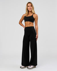 Woman wearing Elixir High-Rise Petite Pant - Black | Model:Issy | Size:XS | Thumbnail Index: 4