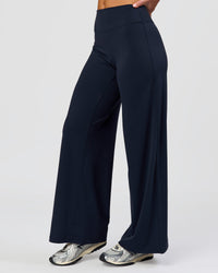 Woman wearing Elixir High-Rise Petite Pant - Midnight Navy | Model:Issy | Size:XS | Thumbnail Index: 1
