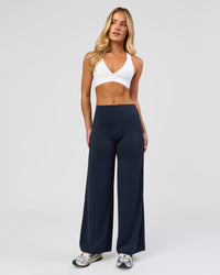 Woman wearing Elixir High-Rise Petite Pant - Midnight Navy | Model:Issy | Size:XS | Thumbnail Index: 0