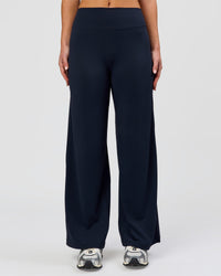 Woman wearing Elixir High-Rise Petite Pant - Midnight Navy | Model:Issy | Size:XS | Thumbnail Index: 8