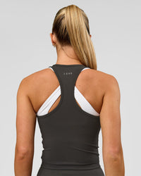 Woman wearing Flow Performance Tank 2.0 - Onyx | Model:Issy | Size:XS | Thumbnail Index: 2