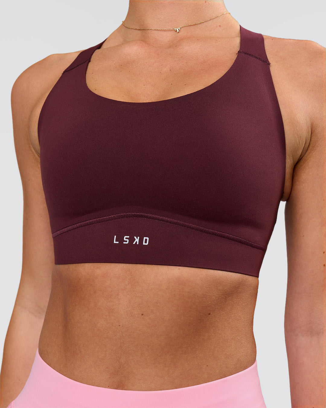 Woman wearing Fusion Sports Bra 2.0 - Cherry Lacquer | Model:Issy | Size:XS - view 1