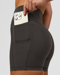 Woman wearing Fusion Ultra High-Rise 4" Short Pockets - Onyx | Model:Issy | Size:XS | Thumbnail Index: 5