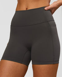 Woman wearing Fusion Ultra High-Rise 4" Short Pockets - Onyx | Model:Issy | Size:XS | Thumbnail Index: 2