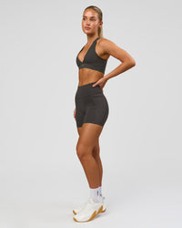 Woman wearing Fusion Ultra High-Rise 4" Short Pockets - Onyx | Model:Issy | Size:XS | Thumbnail Index: 8