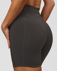 Woman wearing Fusion Ultra High-Rise 6" Short Pockets - Onyx | Model:Issy | Size:XS | Thumbnail Index: 1