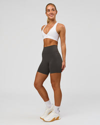 Woman wearing Fusion Ultra High-Rise 6" Short Pockets - Onyx | Model:Issy | Size:XS | Thumbnail Index: 2