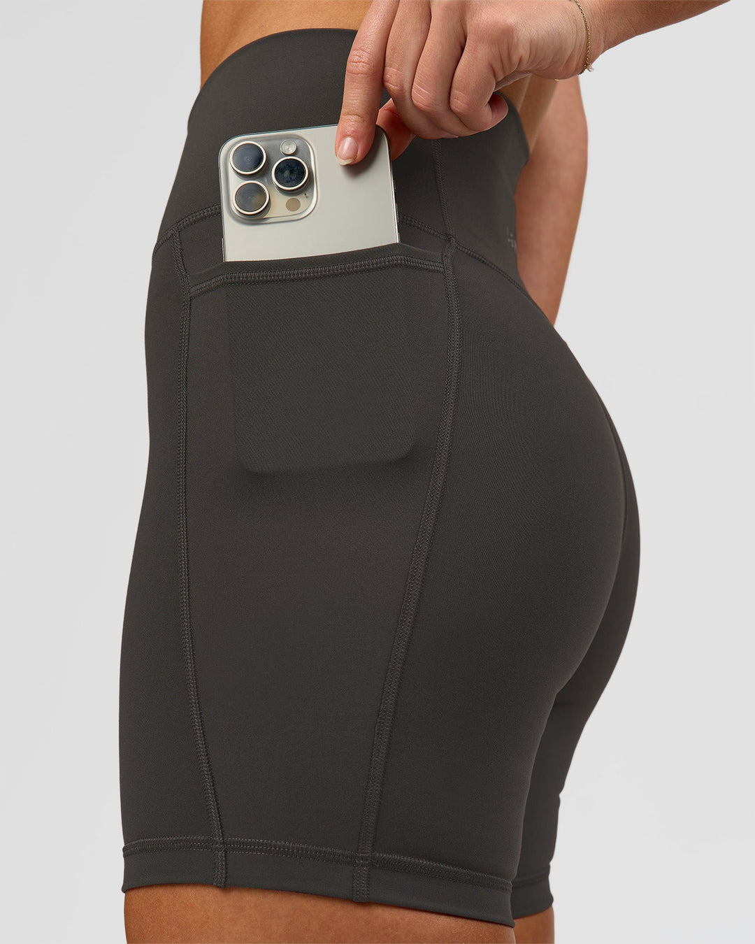Woman wearing Fusion Ultra High-Rise 6" Short Pockets - Onyx | Model:Issy | Size:XS - view 5