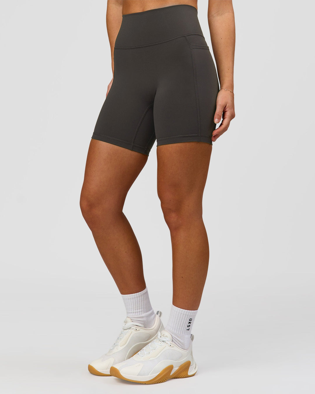 Woman wearing Fusion Ultra High-Rise 6" Short Pockets - Onyx | Model:Issy | Size:XS - view 6