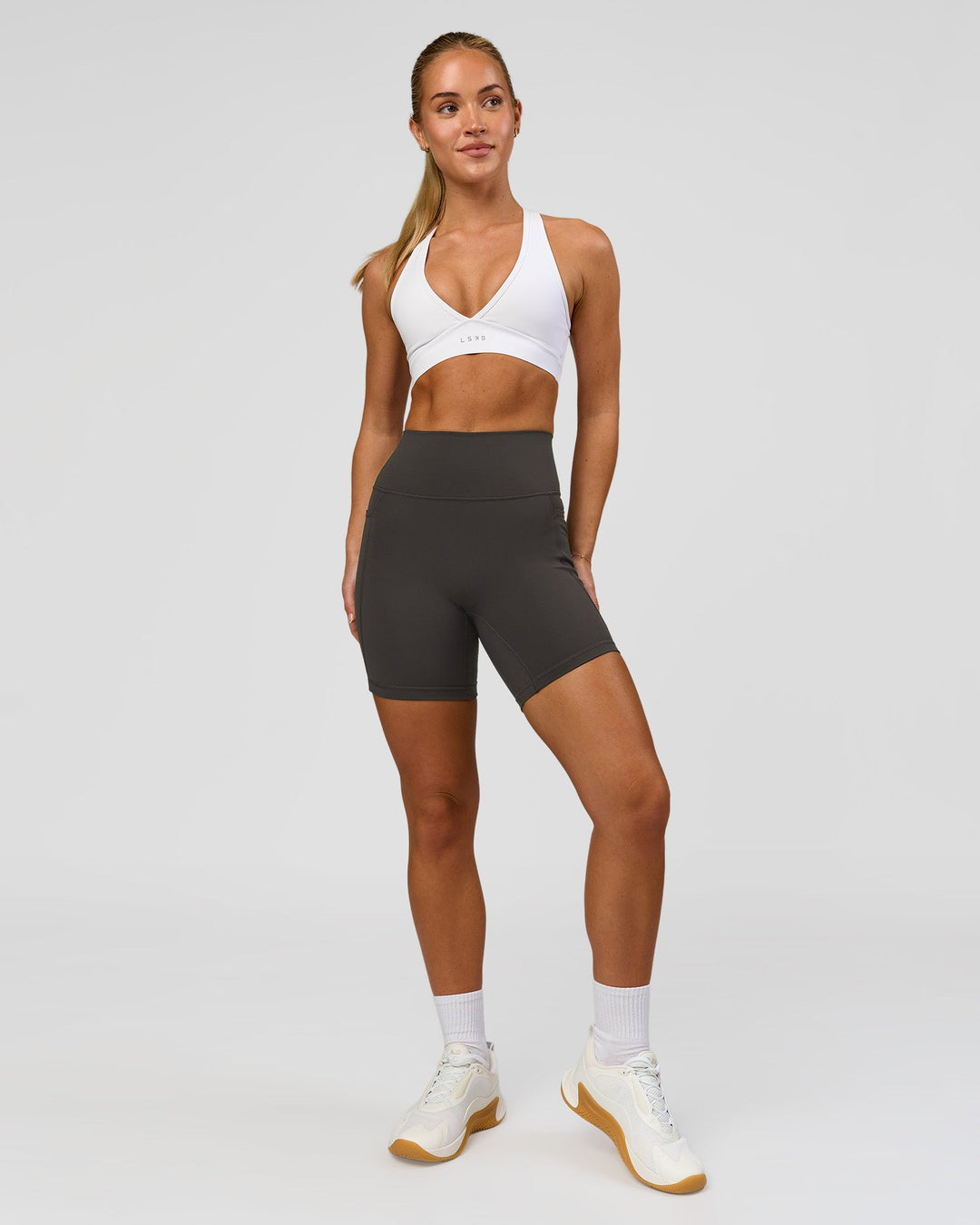Woman wearing Fusion Ultra High-Rise 6" Short Pockets - Onyx | Model:Issy | Size:XS - view 8