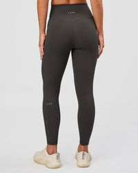 Woman wearing Fusion Ultra High-Rise 7/8 Legging Pockets - Onyx | Model:Issy | Size:XS | Thumbnail Index: 2
