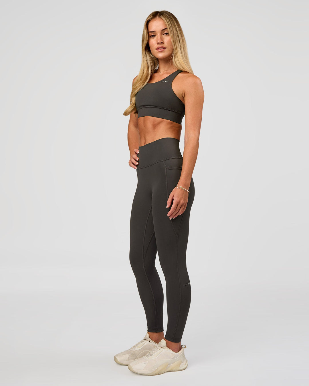 Woman wearing Fusion Ultra High-Rise 7/8 Legging Pockets - Onyx | Model:Issy | Size:XS - view 6
